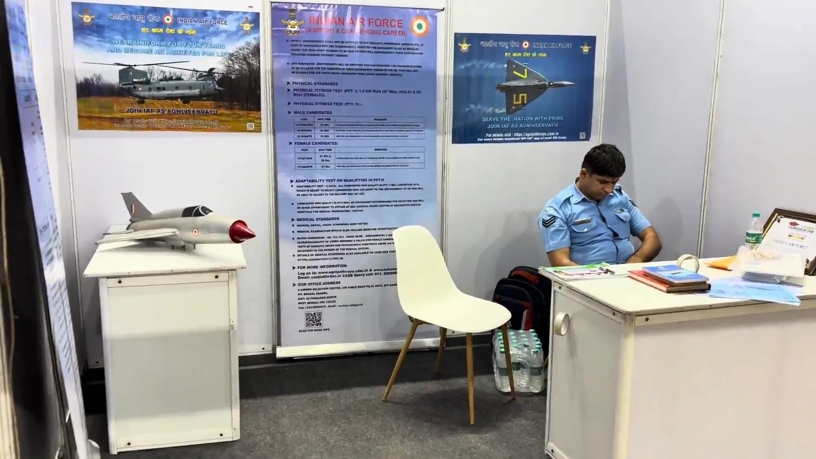An Indian Air Force desk with a model aircraft and information boards behind it.
