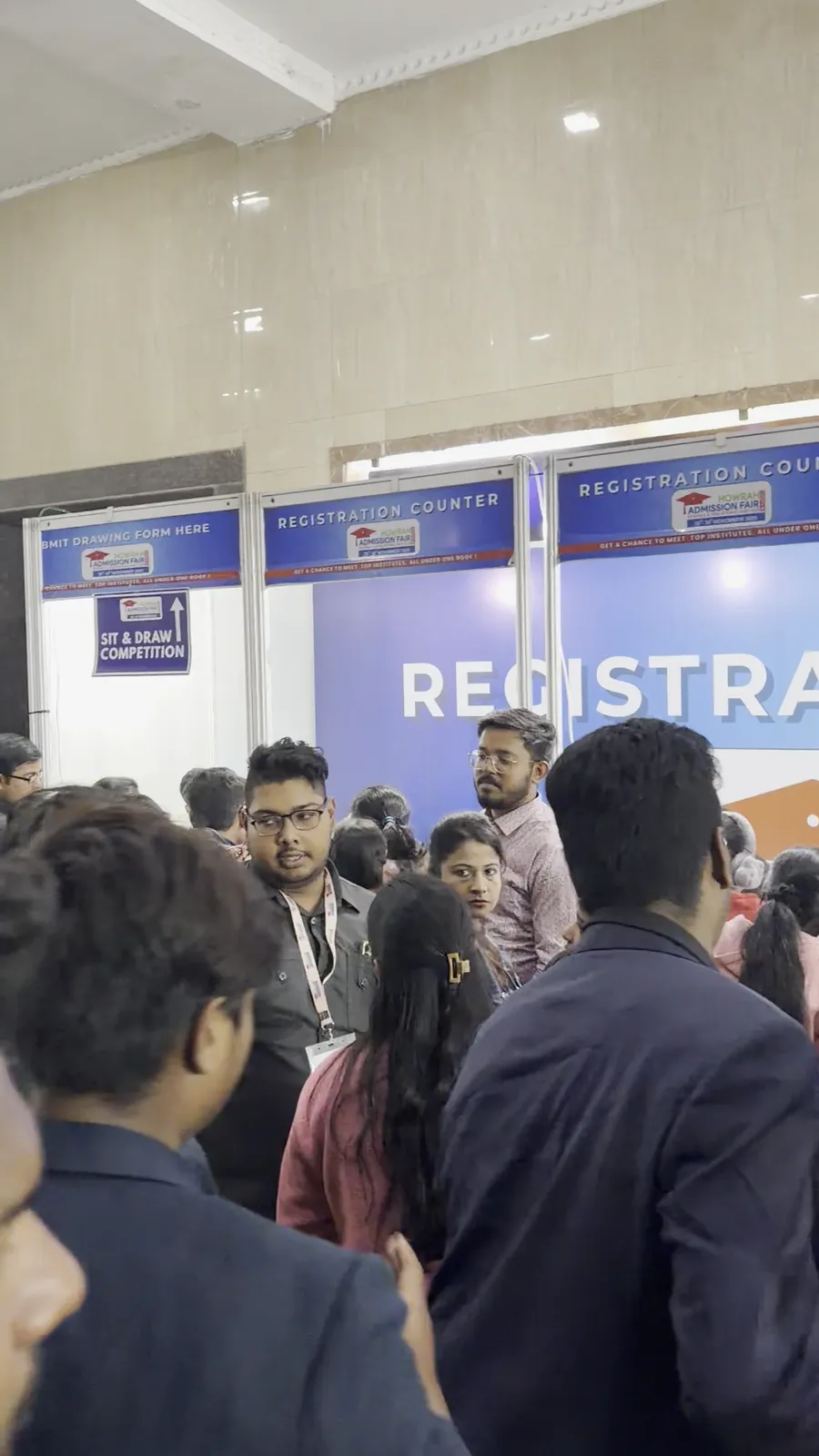 Visitors gathered at the registration counters inside the entrance.