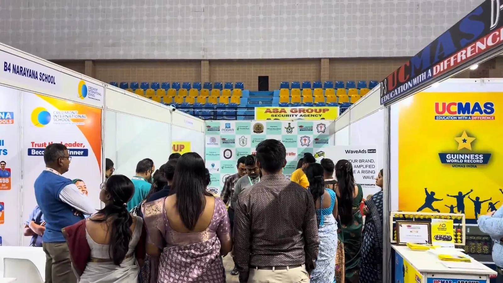 Visitors standing several deep in front of the UCMAS stall.